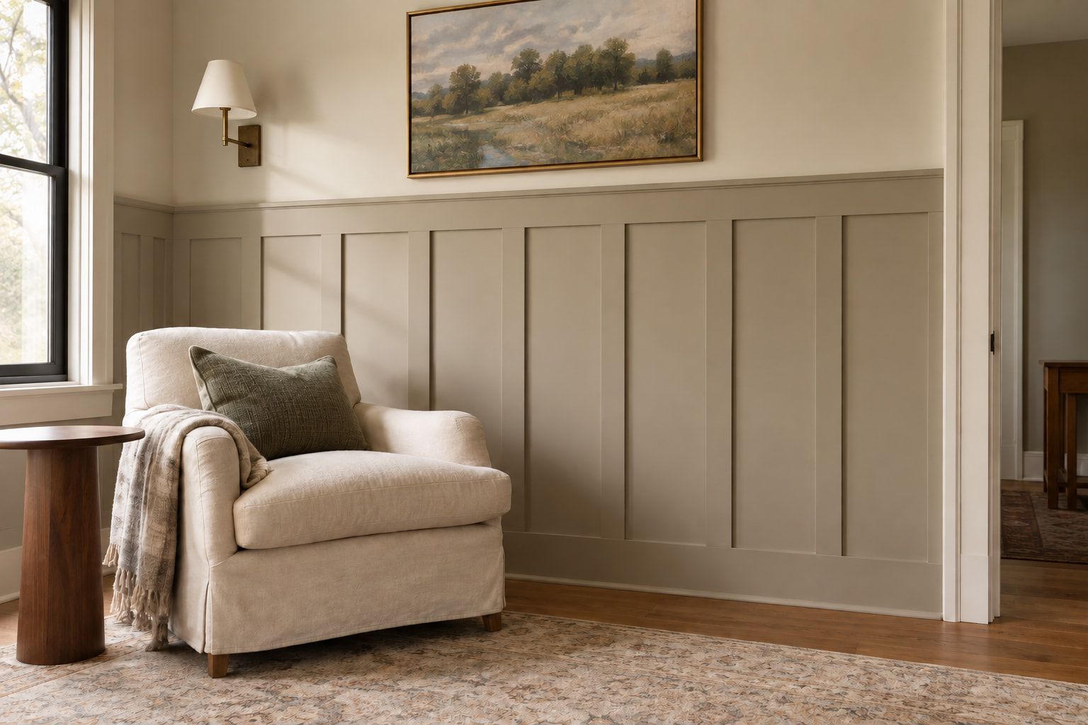 Board-and-batten wainscoting painted warm gray below a cream wall