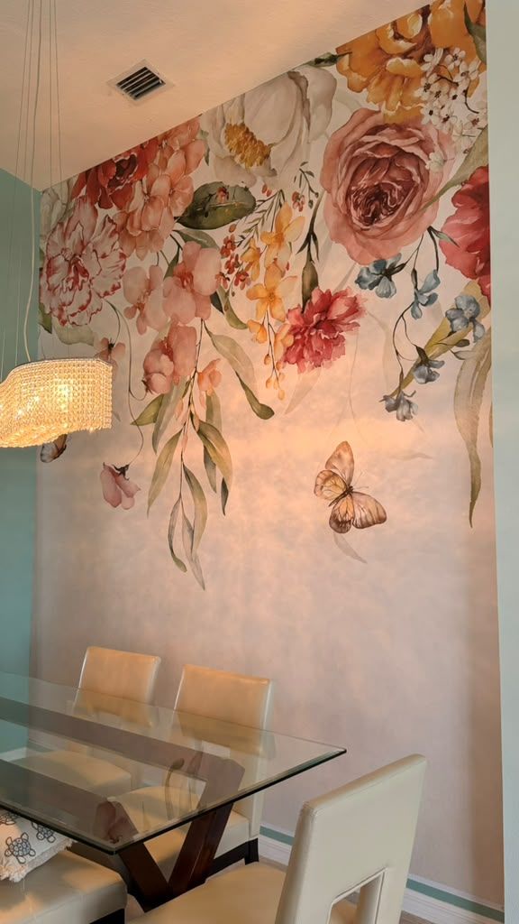 Watercolor floral mural installed floor to ceiling in the dining area, with the pattern aligned across the full wall.