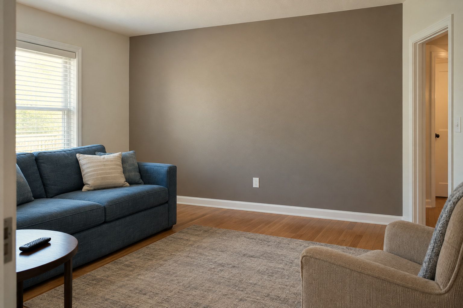 Taupe accent wall with crisp paint lines at the ceiling, corner, and white baseboard